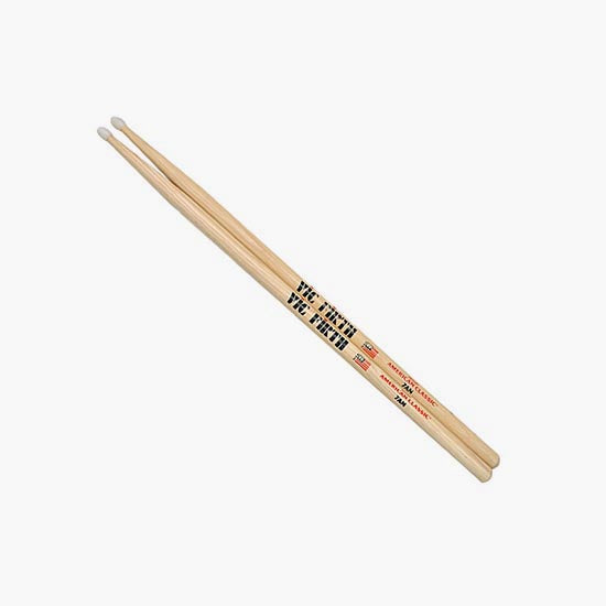 A pair of wooden drumsticks with white tips and black and red text reading 'THE FANTASY VIBRATO' on a light gray background.