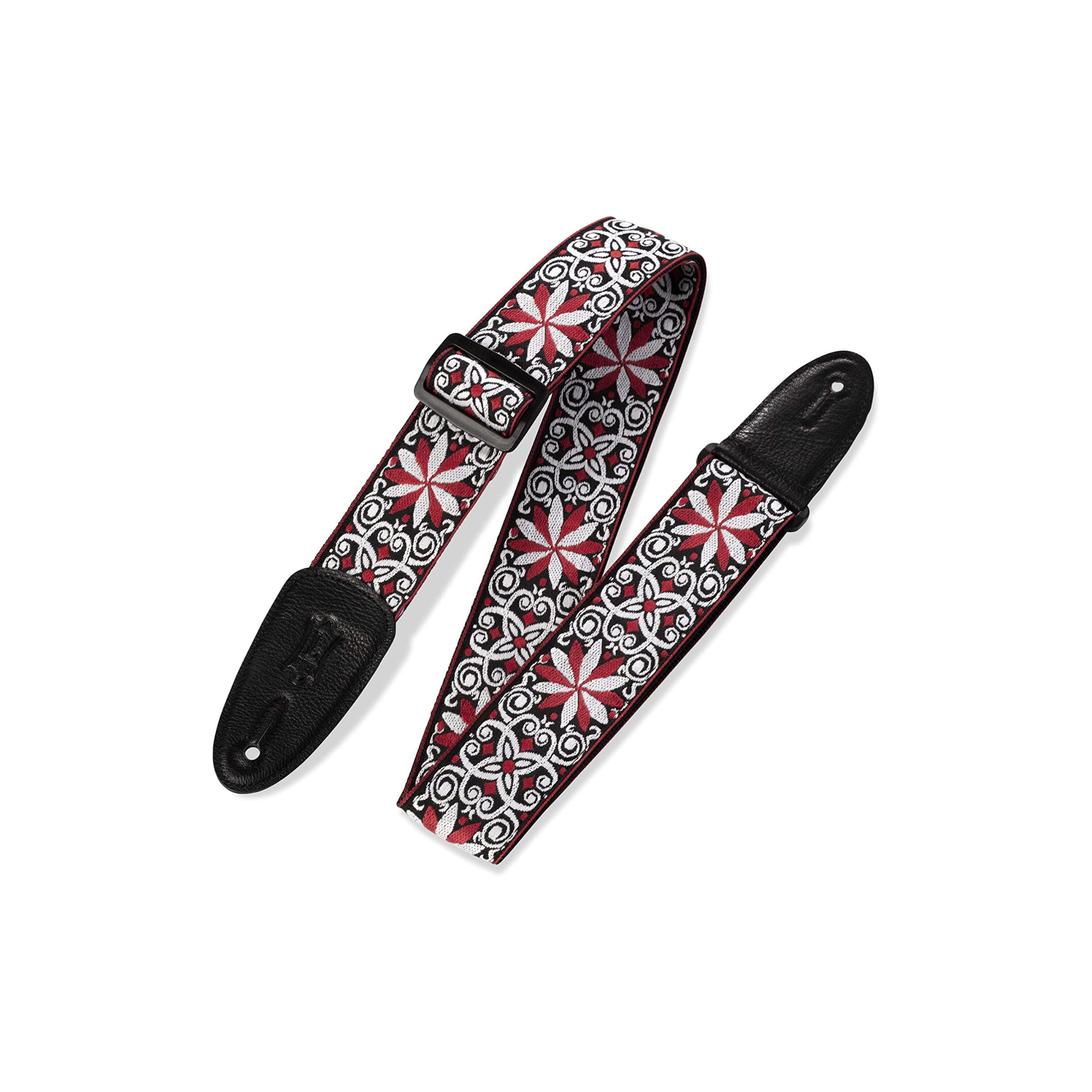 A guitar strap with a black leather end pieces and a woven fabric body featuring a red, white, and black geometric floral pattern, displayed on a clean white background.