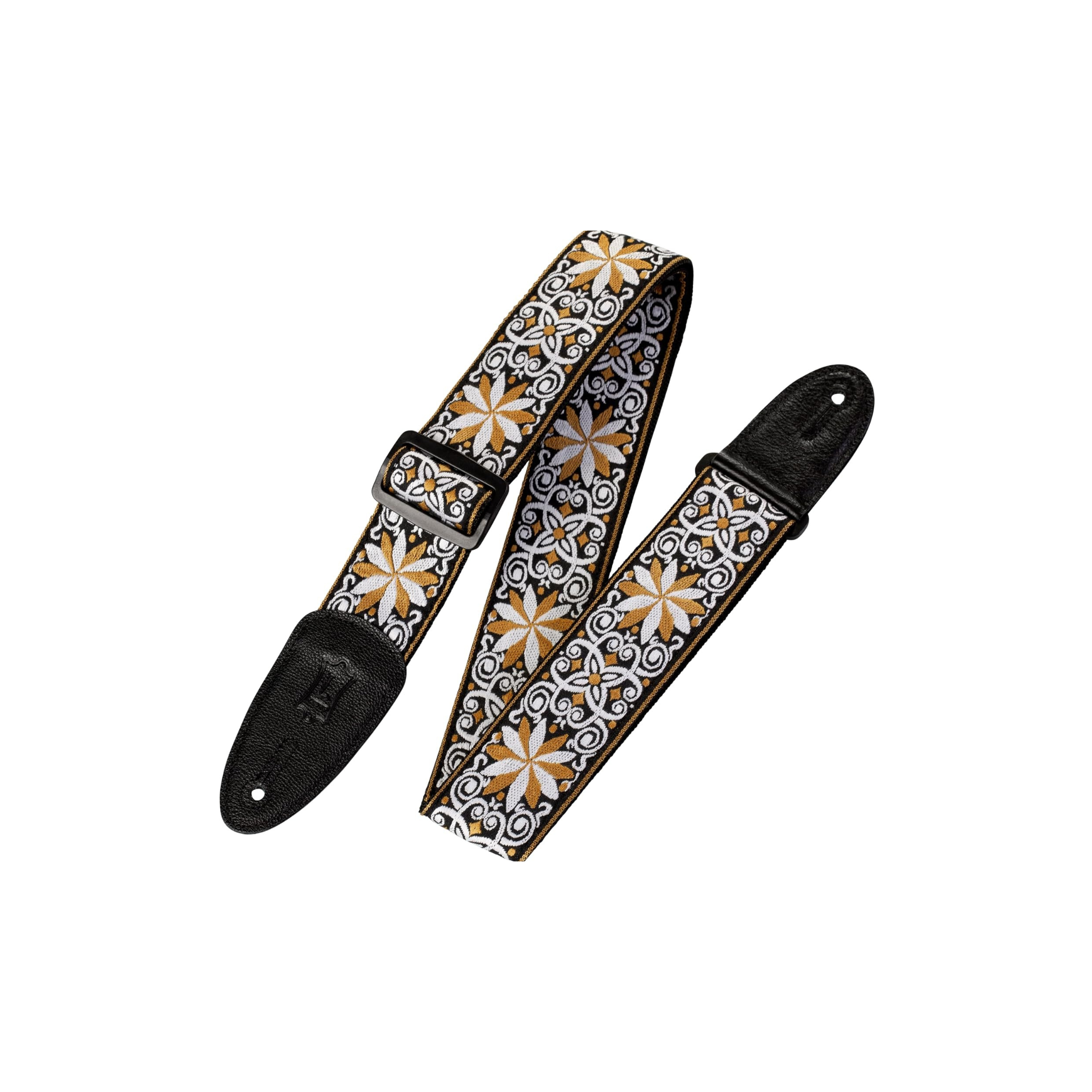 A guitar strap with a black leather end pieces and buckle, featuring a detailed white, gold/beige, and black floral patterned fabric body, shown on a plain white background.