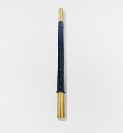 A single long, narrow accessory with a dark navy textured center and natural light wood ends, photographed vertically on a clean white background.